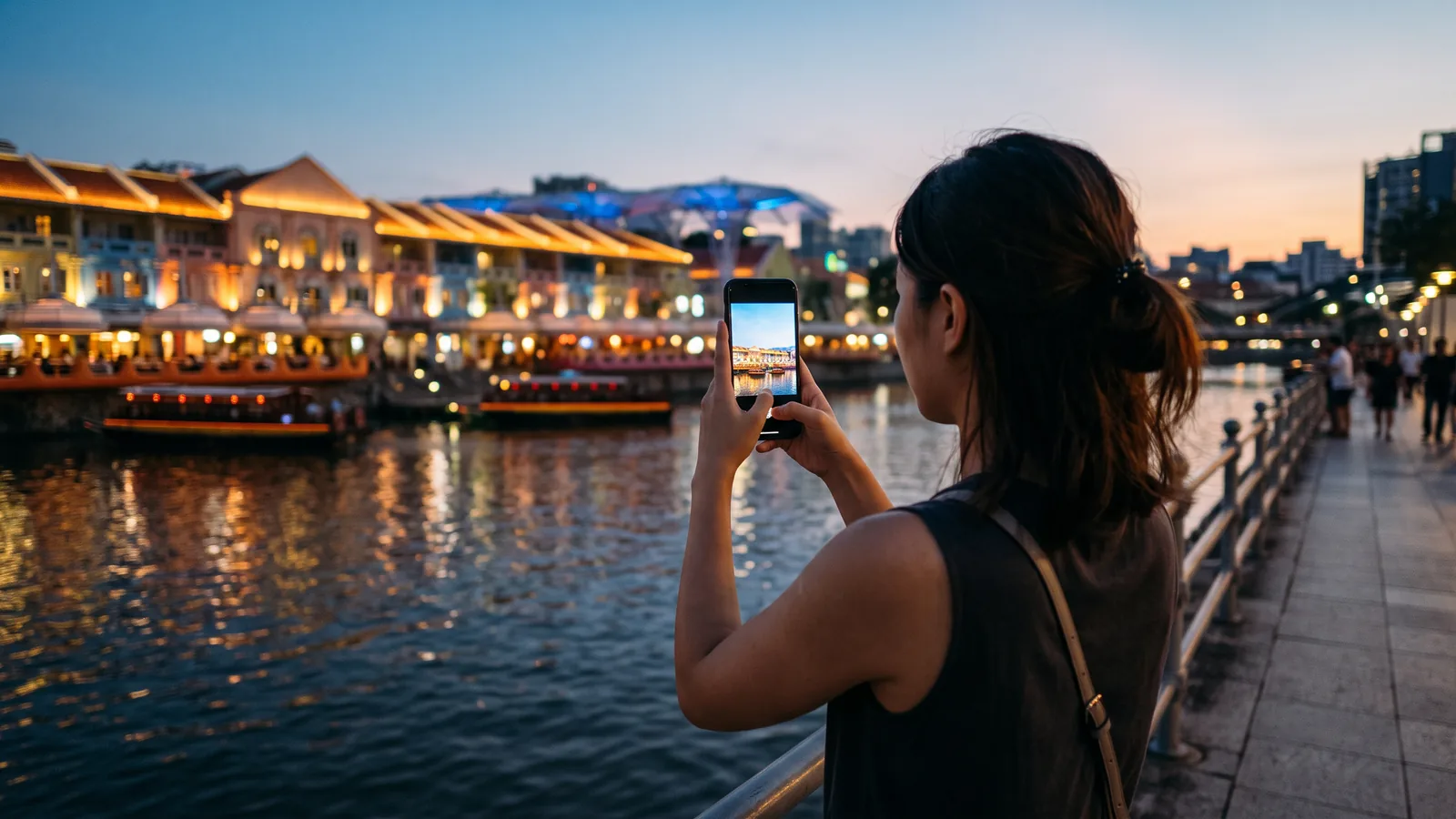 Illustration of a woman photographing the Singapore River at dusk with a generic phone